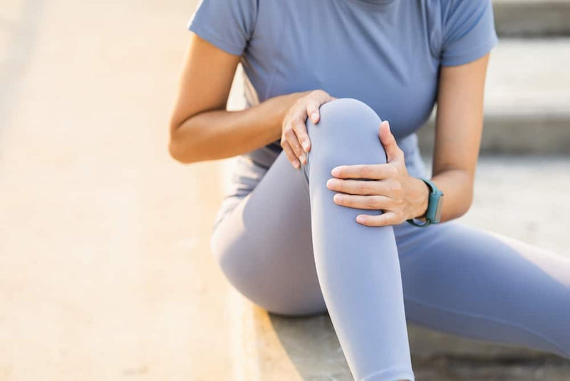 A runner has sore knees because he has been running for too long. Exercising until the injury. Training athlete work out at outdoor concept.