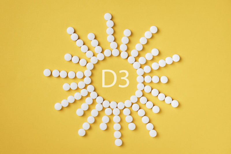 Vitamin D3 - Pillen in Sonnenform angeordnet