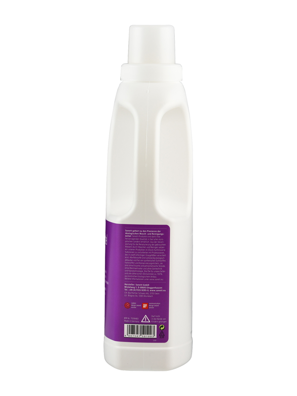Das Bild zeigt eine weiße Kunststoffflasche mit einem violetten Etikett. Die Flasche hat einen Schraubverschluss und enthält Text auf dem Etikett, der schwer lesbar ist. Das Etikett ist auf der Rückseite der Flasche angebracht. Die Flasche steht aufrecht.