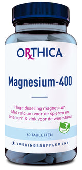 Ein Glasbehälter mit dunkelblauem Deckel, beschriftet mit 'Orthica Magnesium-400'. Enthält 60 Tabletten. Text auf Niederländisch: 'Hoge dosering magnesium. Met calcium voor de spieren en selenium & zink voor de weerstand.' Vegan-Logo.