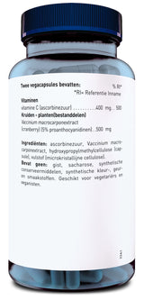 Ein Glasbehälter mit blauem Deckel enthält vegane Kapseln. Das Etikett beschreibt die Inhaltsstoffe: Vitamin C, Cranberry-Extrakt und weitere Zutaten. Es ist für Vegetarier und Veganer geeignet.