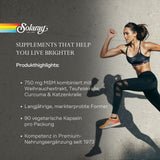 Das Bild zeigt eine Frau in Sportkleidung, die dynamisch springt. Links ist ein Textbereich mit dem Solaray-Logo und dem Slogan "SUPPLEMENTS THAT HELP YOU LIVE BRIGHTER". Darunter sind Produkthighlights aufgelistet: 750 mg MSM kombiniert mit Weihrauchextrakt, Teufelskralle, Curcuma & Katzenkralle, langjährige, markterprobte Formel, 90 vegetarische Kapseln pro Packung, Kompetenz in Premium-Nahrungsergänzung seit 1973. Der Hintergrund ist eine Betonwand.