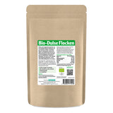 Eine braune, wiederverschließbare Papiertüte mit einem Etikett, das 'Bio-Dulse Flocken' zeigt. Das Etikett enthält Informationen über die Inhaltsstoffe und Nährwerte. Auf dem Etikett ist auch ein QR-Code zu sehen, sowie der Hinweis auf Bio-Qualität. Die Tüte steht aufrecht vor einem weißen Hintergrund.