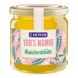 Glas Honig von Hoyer, Akazienblüte, Bio, 100% Honig, rosa Etikett mit Blumenmuster.