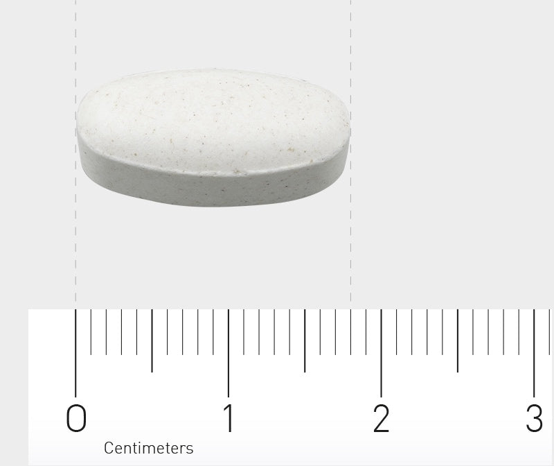 Das Bild zeigt eine weiße, ovale Tablette auf einem Lineal. Die Tablette misst etwa 2 Zentimeter. Der Hintergrund ist grau.