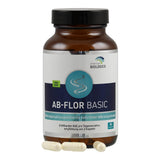 Eine braune Flasche mit einem weißen Etikett, auf dem "AB-FLOR BASIC" steht. Die Flasche enthält Nahrungsergänzungsmittel mit natürlichen Mikroorganismen. Auf dem Etikett ist auch "american BIOLOGICS" und "NON GMO" zu sehen. Drei Kapseln liegen vor der Flasche.