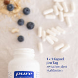 Das Bild zeigt eine geöffnete Flasche von Pure Encapsulations mit weißen Kapseln auf einem hellen Untergrund. Daneben liegen Blaubeeren und Nüsse. Text auf dem Bild: '1 x 1 Kapsel pro Tag zwischen den Mahlzeiten'.
