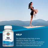 Eine Frau in Sportkleidung steht auf einem Felsen und dehnt ihr Bein vor einer Berglandschaft. Unten links ist eine Flasche Kelp-Nahrungsergänzungsmittel mit 225 mcg Jod abgebildet. Der Hintergrund ist ein klarer blauer Himmel. Der Text beschreibt die Vorteile von Kelp für die Schilddrüsenfunktion.