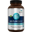 Eine braune Flasche mit schwarzem Deckel, auf der ein Etikett mit Informationen zu einem Nahrungsergänzungsmittel namens AB-Flora Basic angebracht ist. Das Etikett beschreibt die Inhaltsstoffe, Verzehrempfehlung und Hinweise zur Nutzung. Unten befindet sich ein Barcode. Die Flasche steht vor einem weißen Hintergrund.