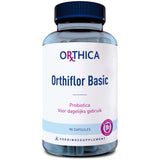 Eine blaue Plastikflasche mit weißem Etikett, auf dem "Orthica Orthiflor Basic" steht. Enthält 90 Kapseln Probiotika zur täglichen Verwendung. Das Etikett zeigt auch ein pinkfarbenes Logo und den Text "VOEDINGSSUPPLEMENT".