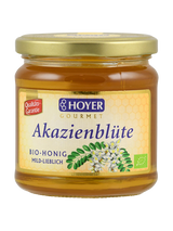 Ein Glas Hoyer Gourmet Akazienblüte Bio-Honig, mild-lieblich, mit Qualitäts-Garantie-Siegel.