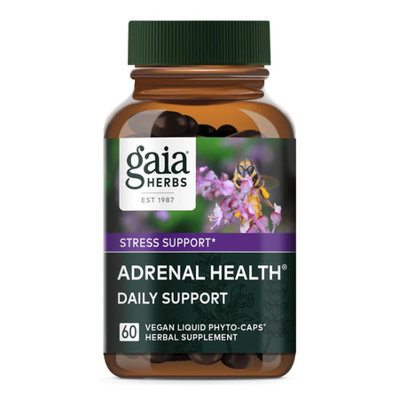 Das Bild zeigt eine braune Flasche mit einem grünen Deckel. Auf dem Etikett steht 'gaia HERBS', 'STRESS SUPPORT', und 'ADRENAL HEALTH DAILY SUPPORT'. Es sind 60 vegane Flüssigkapseln enthalten. Im Hintergrund ist eine Biene auf einer lila Blume abgebildet.