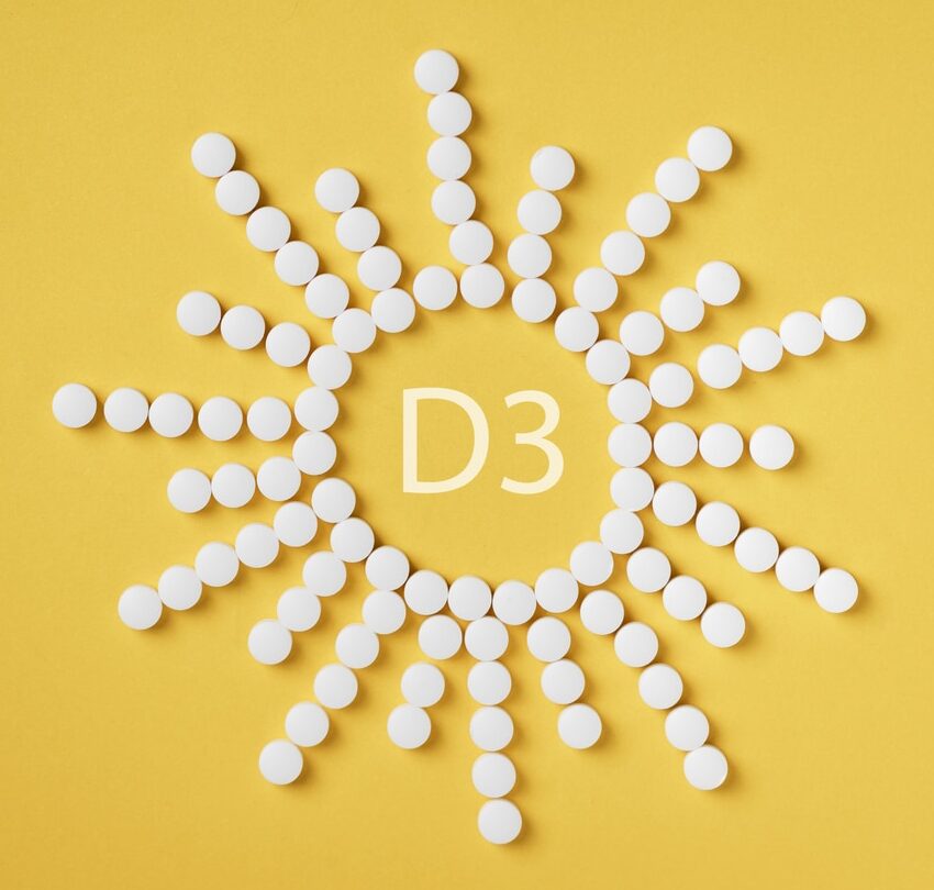 Vitamin D3 - Tabletten in Sonnenform angeordnet